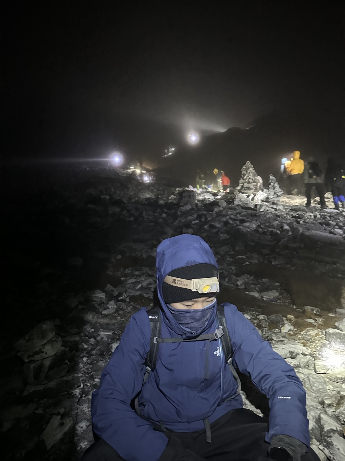 Zhuohan resting during a rocky hike before dawn