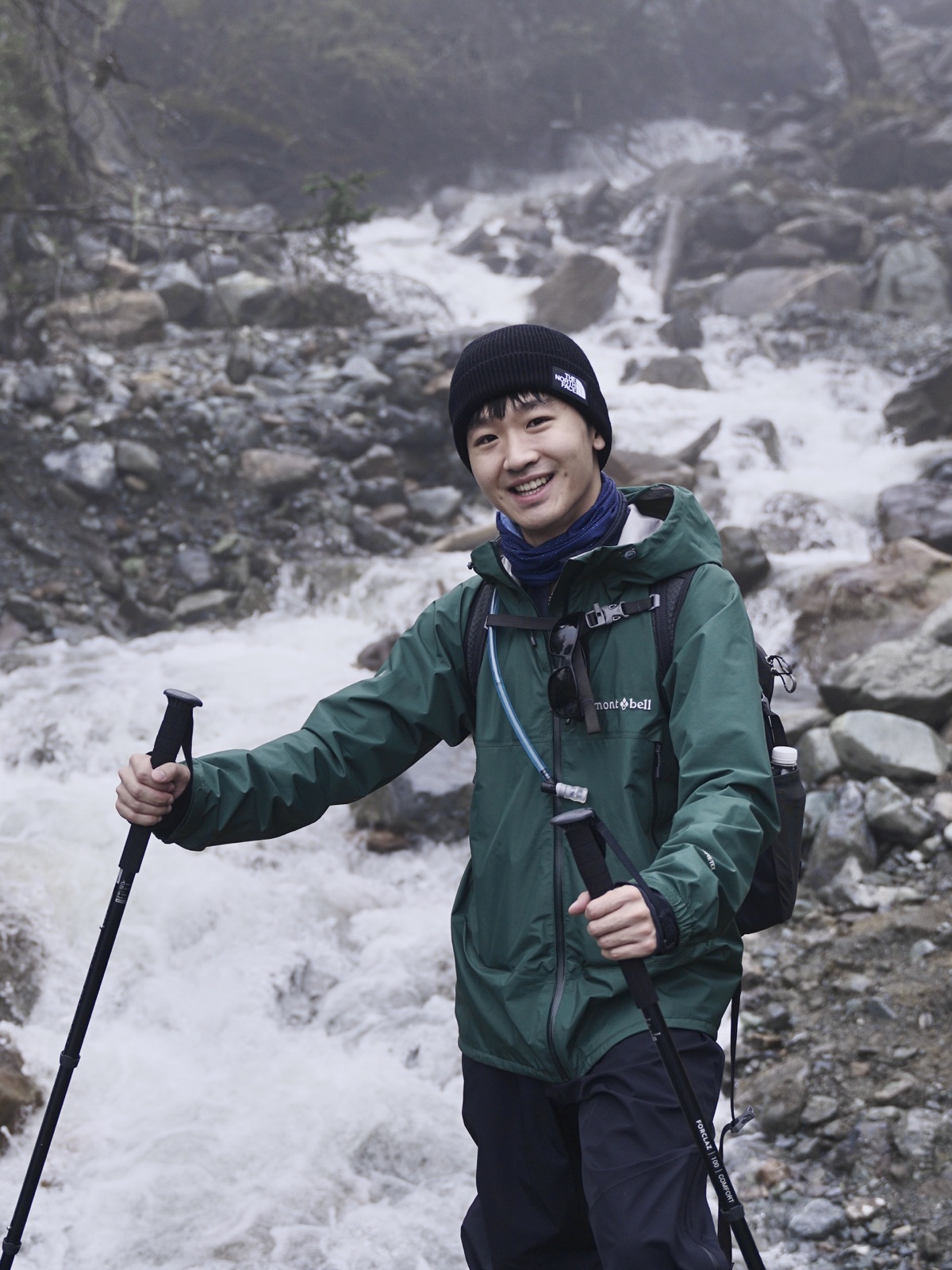 Zhuohan hiking beside a frozen mountain stream
