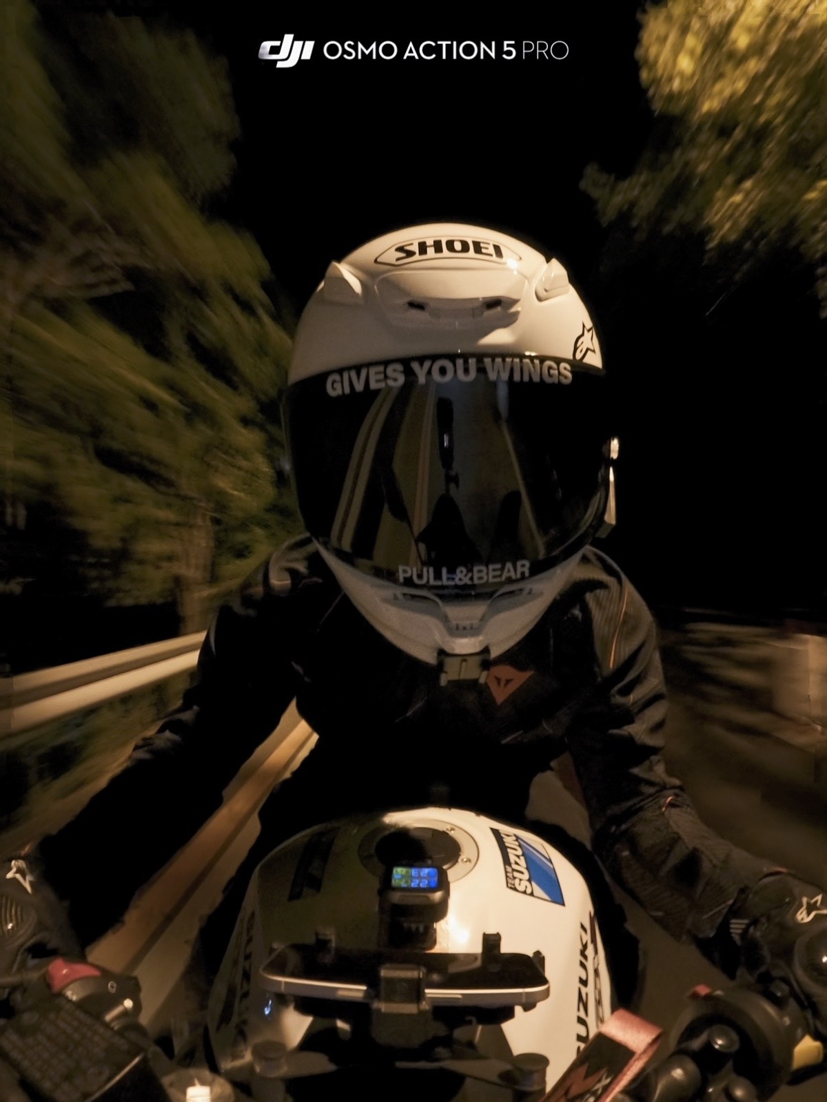 A close action-camera view of Zhuohan riding a motorcycle at night