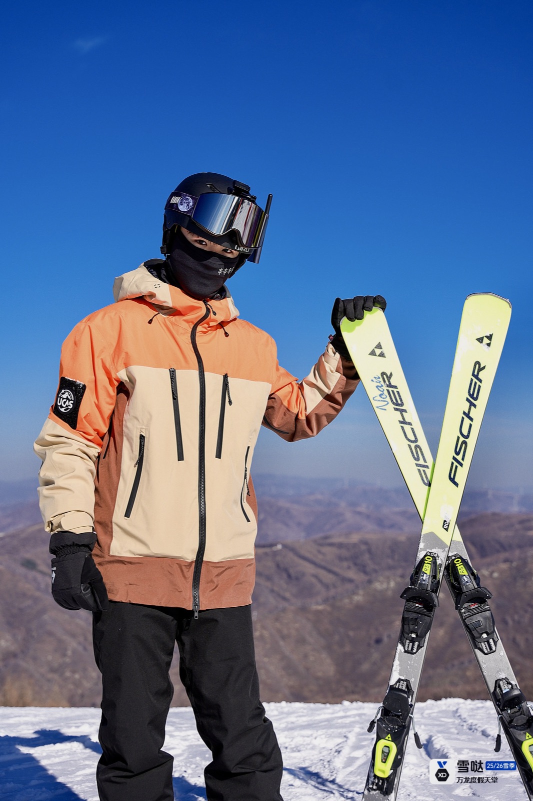 Zhuohan standing on a snowy mountain with a pair of skis